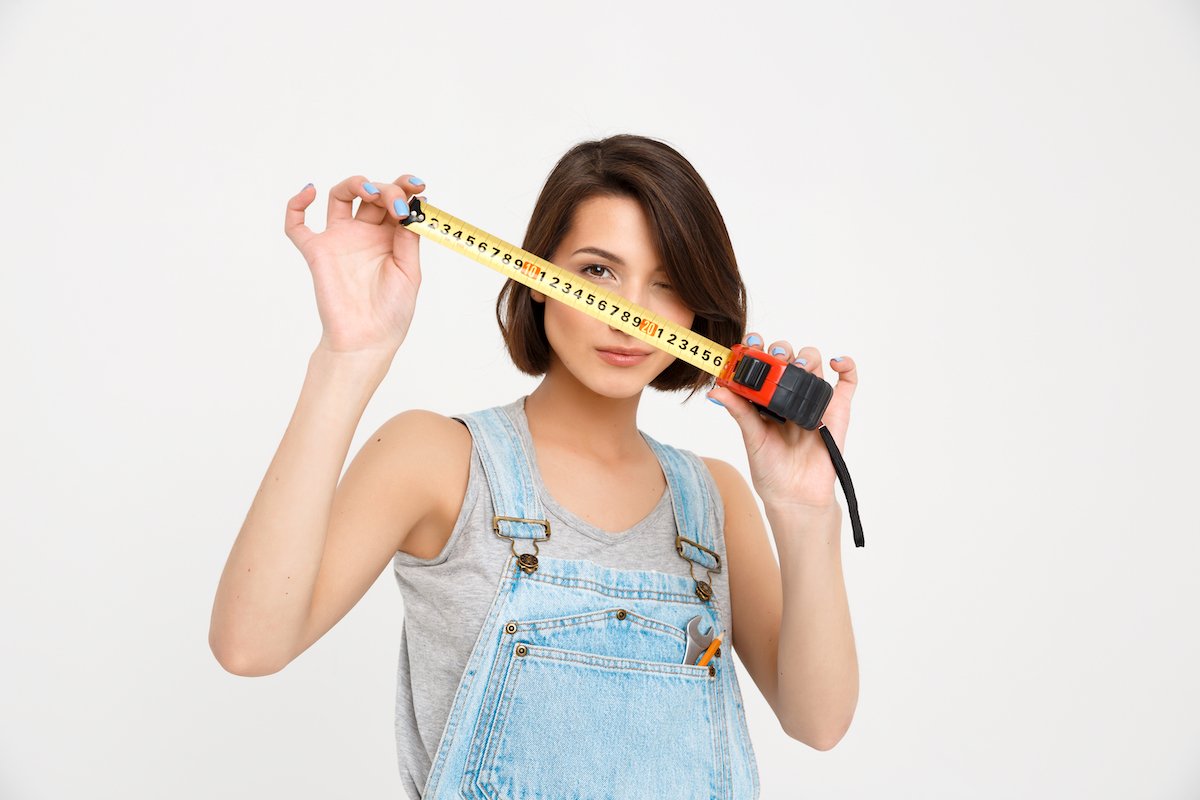 portrait of young beautiful girl, holding tape measure